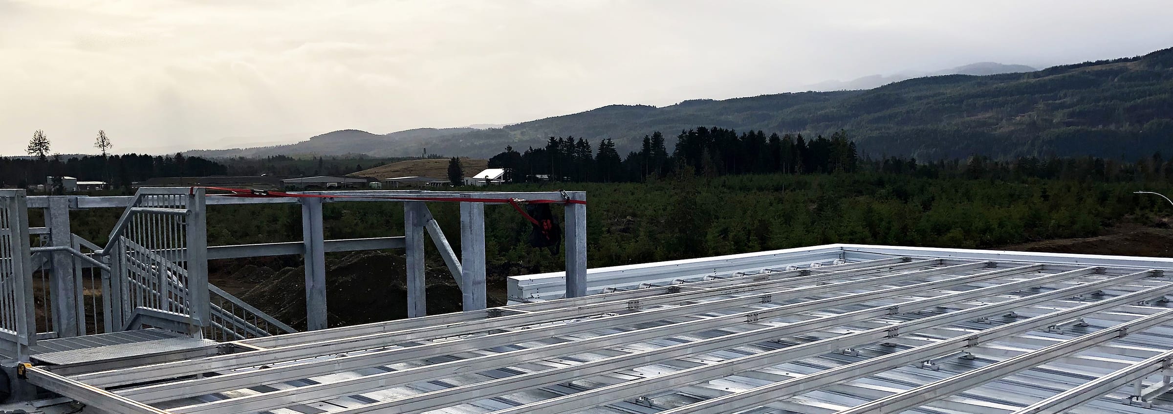 Unfinished bolted aluminum frame on a roof, before decking is installed.